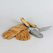 Brown leather gloves and metal gardening tools with wood handles